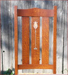 Another chair from the lighter stained set displaying the inlaid slat. 